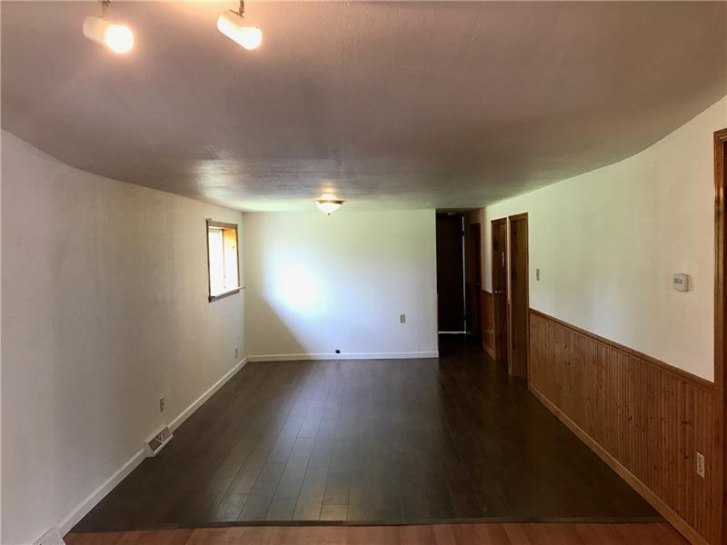 1102 Grant Street Bulger, PA 15019 - Photo 11 of 25 a view of an empty room with wooden floor and a window