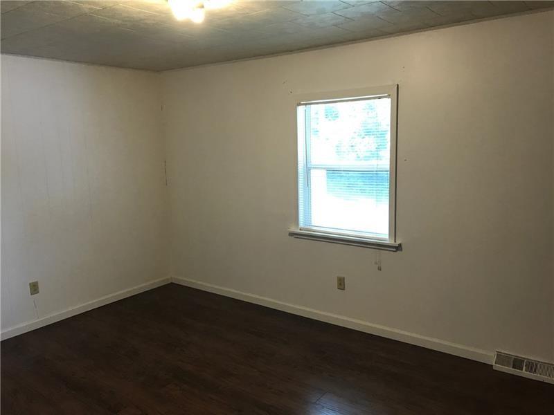 1102 Grant Street Bulger, PA 15019 - Photo 13 of 25 an empty room with wooden floor and windows