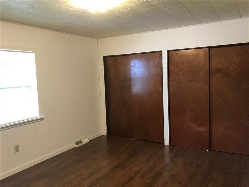 1102 Grant Street Bulger, PA 15019 - Photo 14 of 25 an empty room with wooden floor and windows