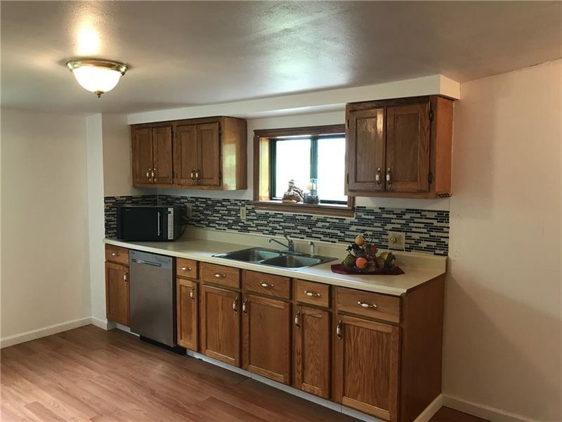 1102 Grant Street Bulger, PA 15019 - Photo 5 of 25 a kitchen with stainless steel appliances granite countertop a sink and wooden cabinets