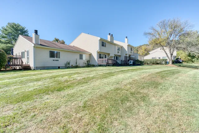 a view of a house with a backyard