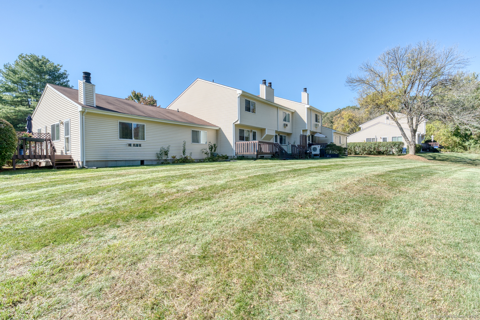 12 Stone Pond Road, Unit 12 Tolland, CT 06084 - Photo 26 of 31 a big house with a big yard and large trees