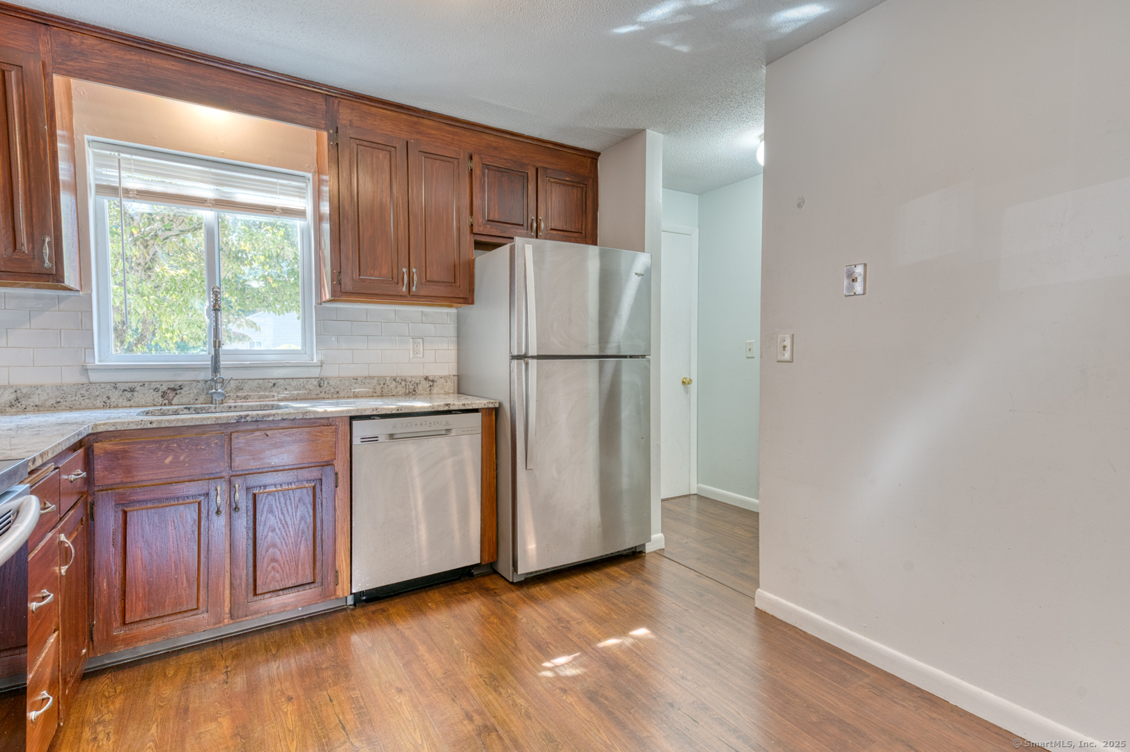 12 Stone Pond Road, Unit 12 Tolland, CT 06084 - Photo 9 of 31 a kitchen with granite countertop a refrigerator sink and cabinets