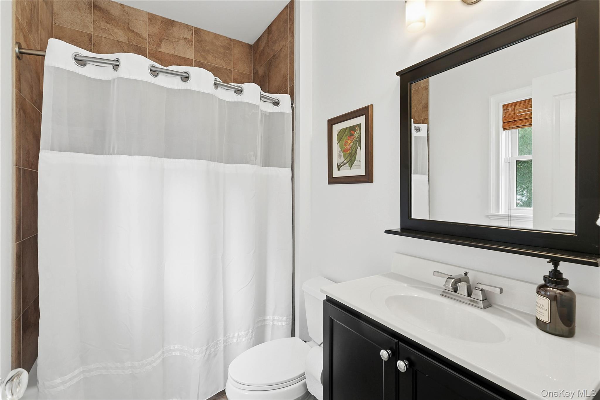 3470 North Bayview Road Southold, NY 11971 - Photo 9 of 25 Full bath off bedroom 2 featuring vanity and curtained shower