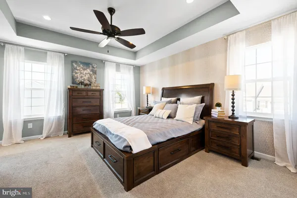 a bedroom with a bed dresser and a window