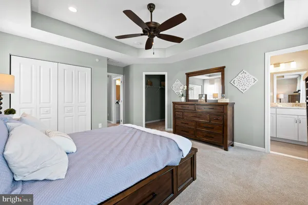 a bedroom with a bed and ceiling fan