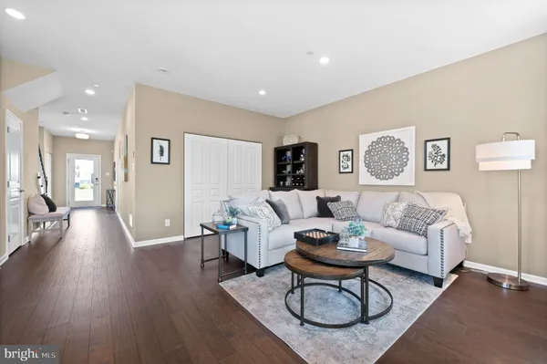 a living room with furniture a wooden floor and a chandelier