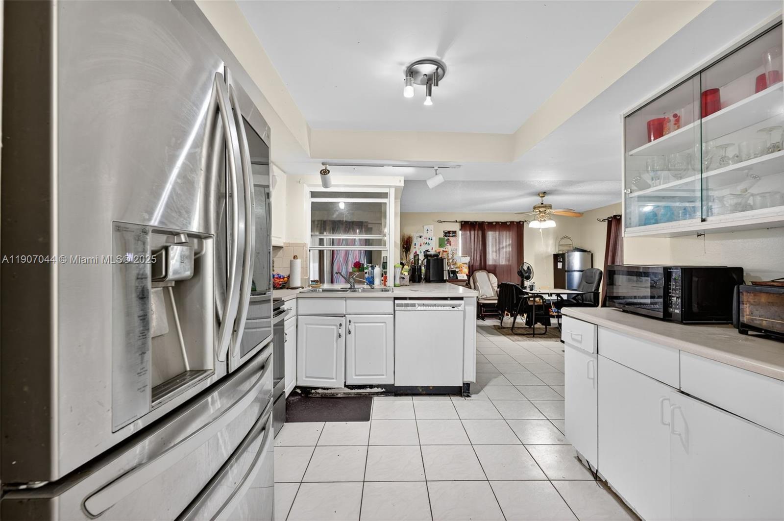 849 Northwest 70th Way Margate, FL 33063 - Photo 11 of 29 a kitchen with sink cabinets and stove top oven