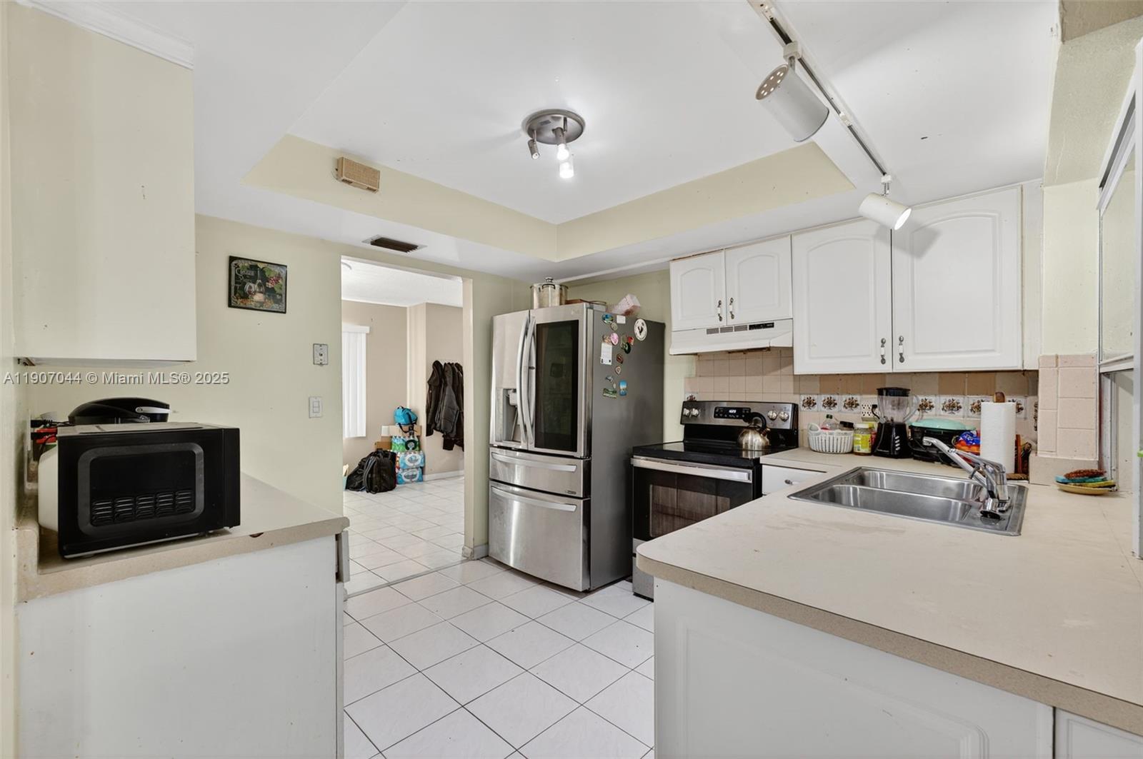849 Northwest 70th Way Margate, FL 33063 - Photo 12 of 29 a kitchen with refrigerator and stove top oven