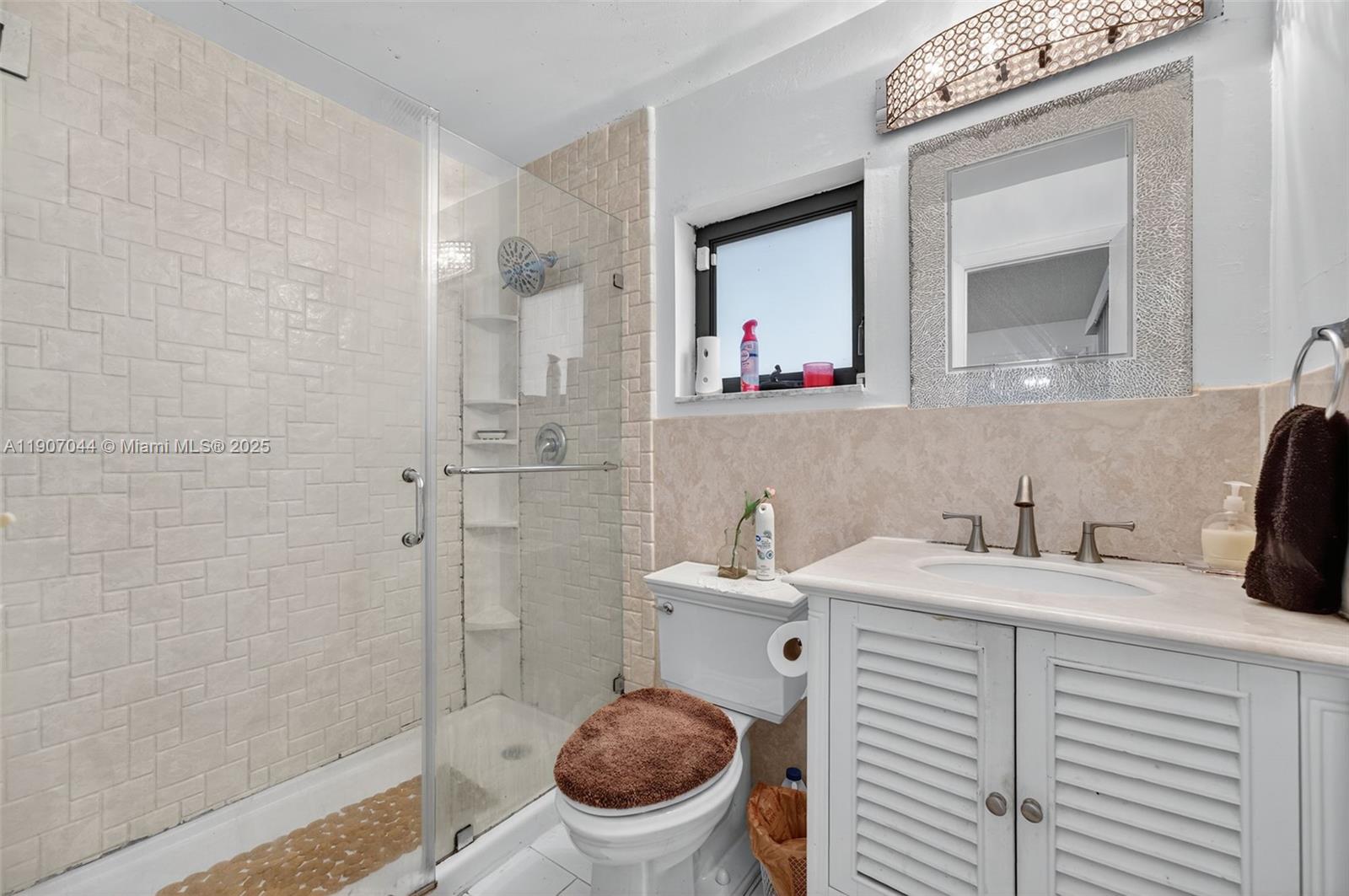 849 Northwest 70th Way Margate, FL 33063 - Photo 22 of 29 a bathroom with a sink a toilet and a mirror