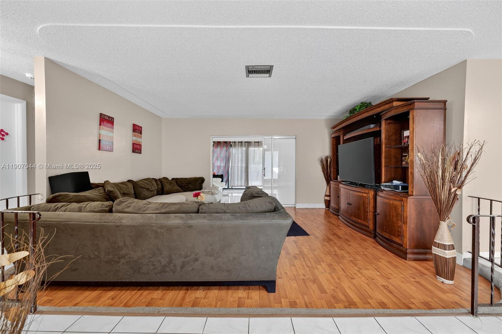849 Northwest 70th Way Margate, FL 33063 - Photo 4 of 29 a living room with furniture and a flat screen tv