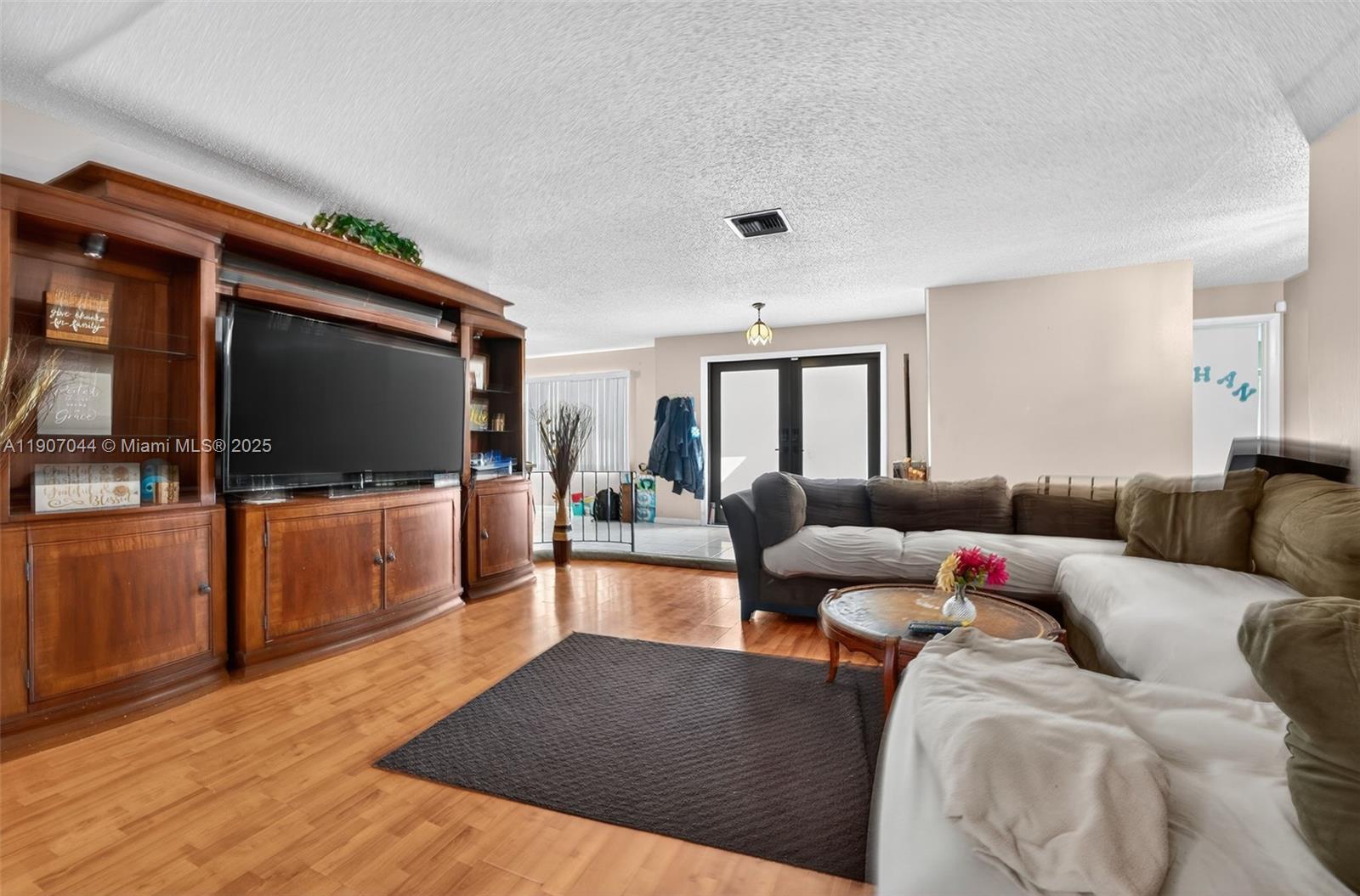 849 Northwest 70th Way Margate, FL 33063 - Photo 7 of 29 a living room with furniture and a flat screen tv