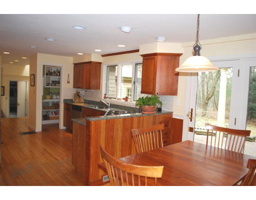 247 Nashoba Road Concord, MA 01742 - Photo 11 of 23 a living room with stainless steel appliances kitchen island granite countertop furniture and a wooden floor