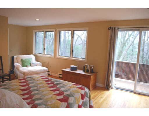 247 Nashoba Road Concord, MA 01742 - Photo 14 of 23 a bedroom with a bed and glass windows