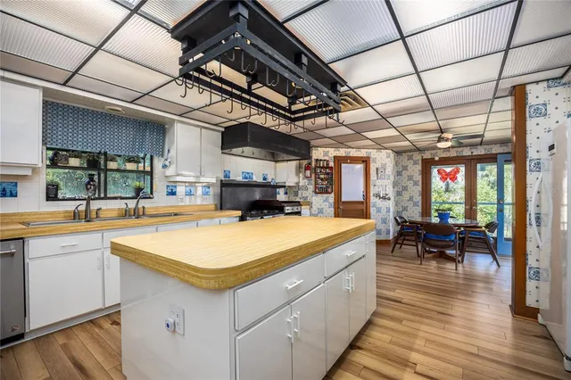 a kitchen with kitchen island a sink and stove