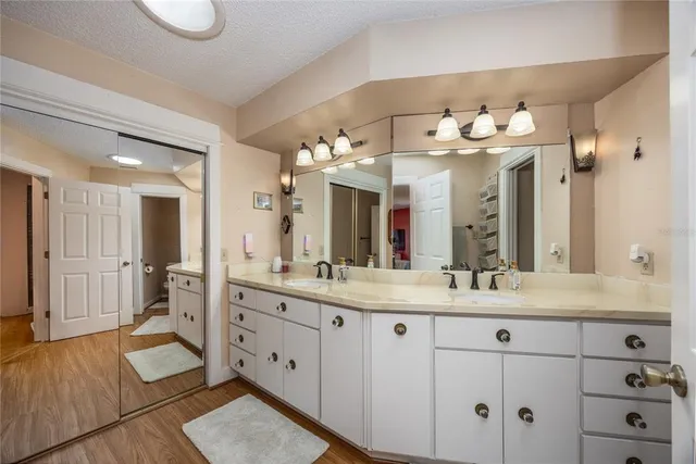 a bathroom with a double vanity sink and a mirror