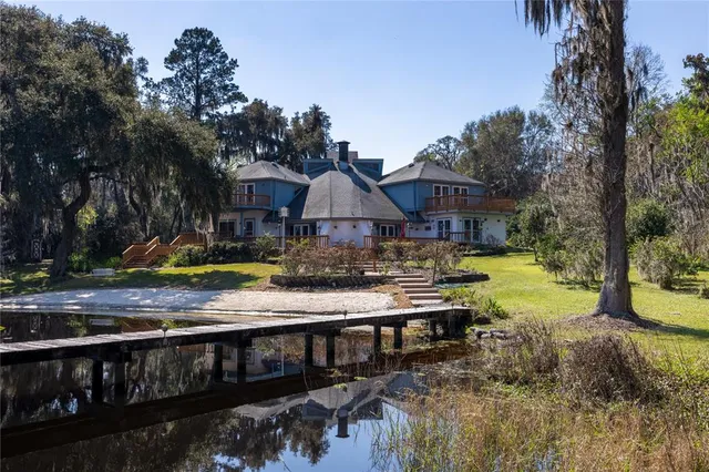 a view of swimming pool with sitting area and garden
