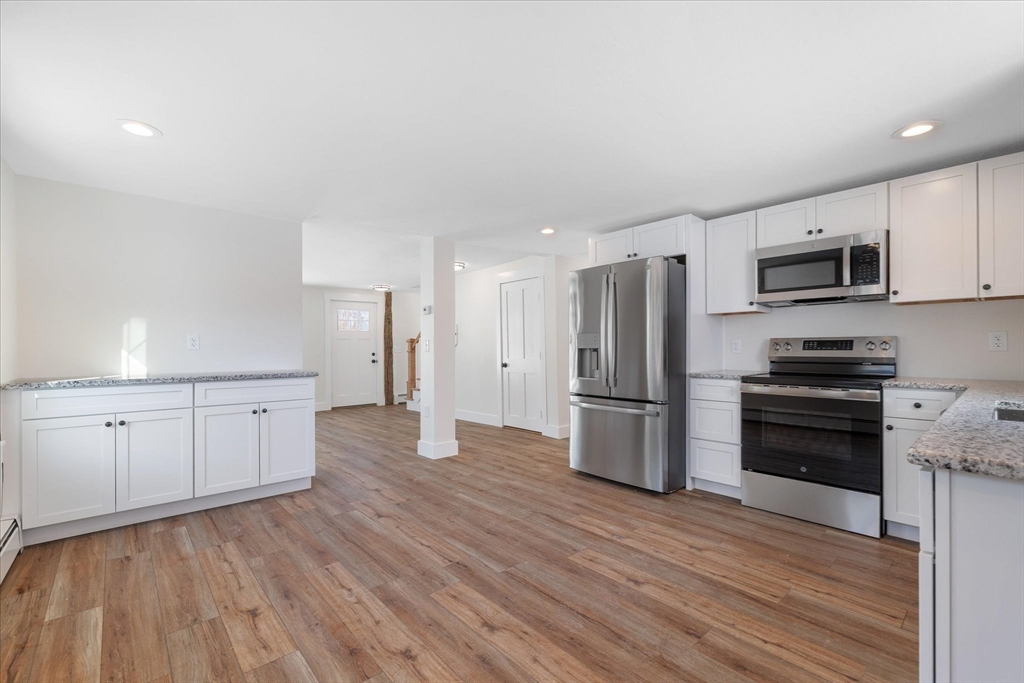 67 Maple Street Oakham, MA 01068 - Photo 11 of 42 a kitchen with stainless steel appliances a refrigerator and a stove top oven