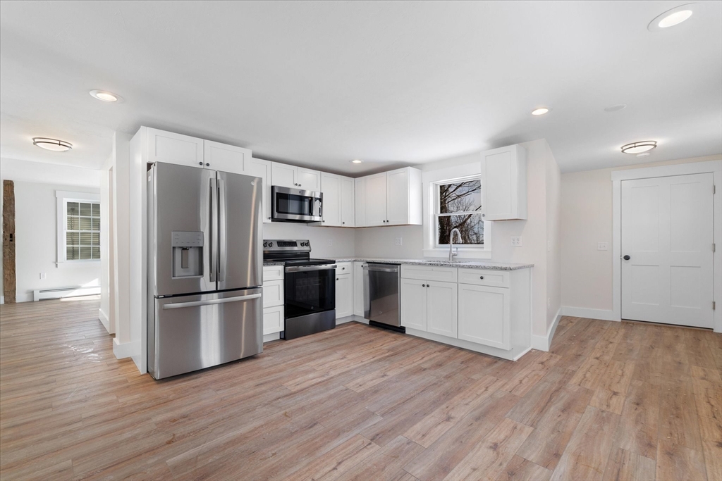 67 Maple Street Oakham, MA 01068 - Photo 11 of 41 a kitchen with stainless steel appliances a refrigerator sink and cabinets