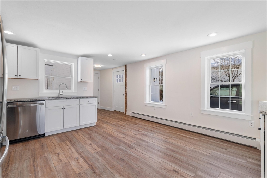 67 Maple Street Oakham, MA 01068 - Photo 13 of 42 a large kitchen with hard wood floors and white cabinets