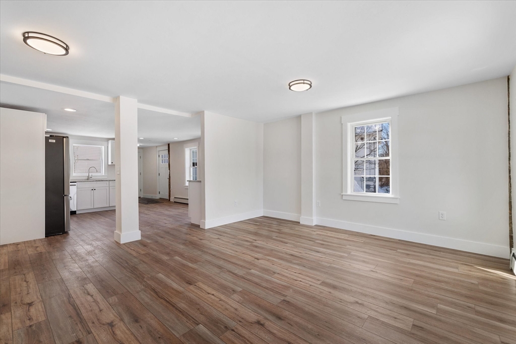 67 Maple Street Oakham, MA 01068 - Photo 14 of 42 a view of a big room with wooden floor and a window
