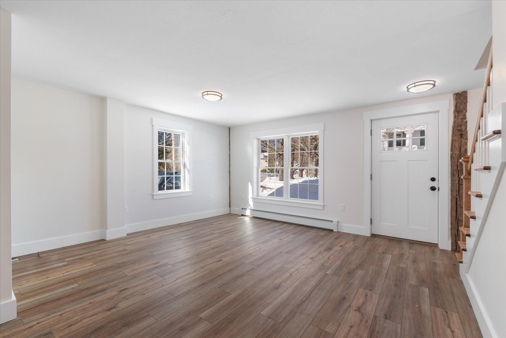 67 Maple Street Oakham, MA 01068 - Photo 17 of 42 a view of an empty room with wooden floor and a window
