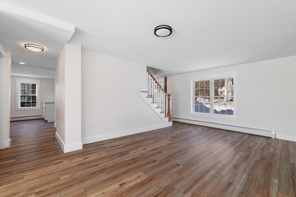 67 Maple Street Oakham, MA 01068 - Photo 20 of 41 an empty room with wooden floor and windows
