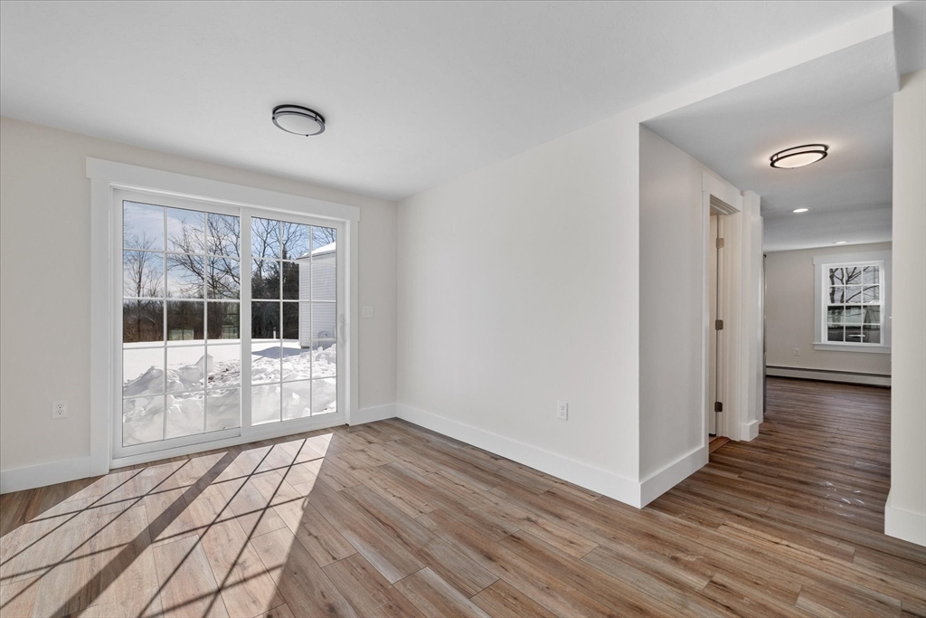 67 Maple Street Oakham, MA 01068 - Photo 22 of 41 a view of empty room with wooden floor and fan