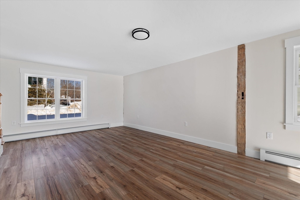 67 Maple Street Oakham, MA 01068 - Photo 23 of 41 a view of an empty room with wooden floor and a window