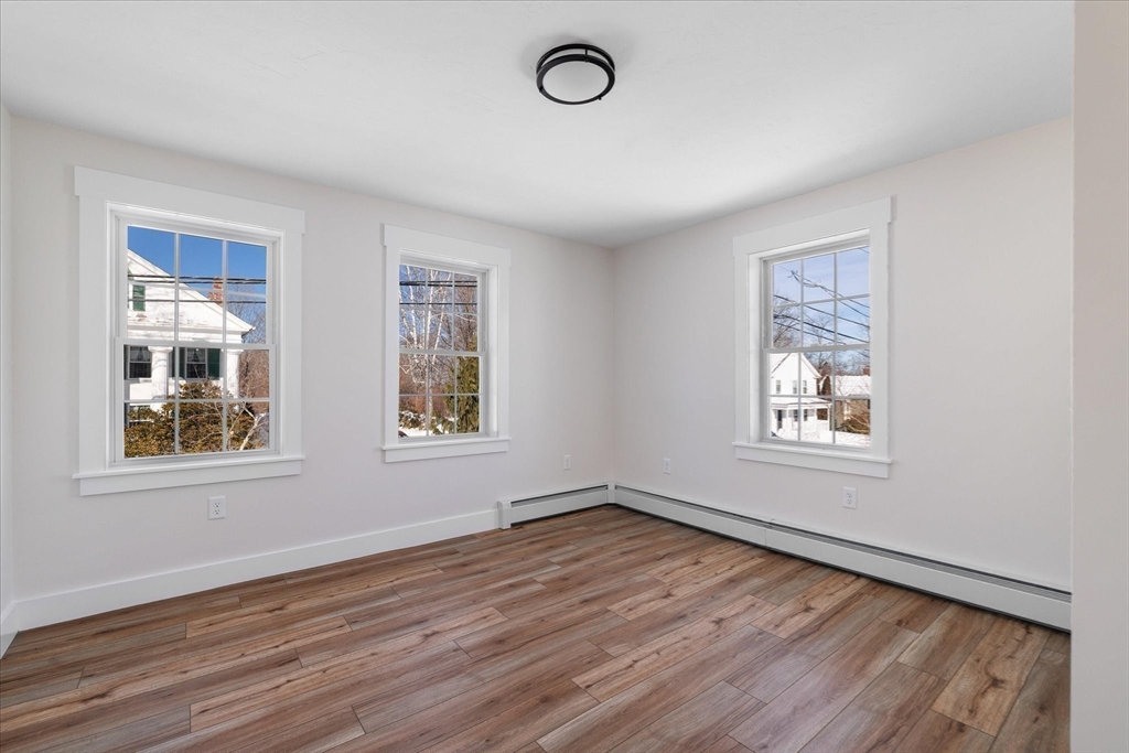 67 Maple Street Oakham, MA 01068 - Photo 34 of 42 a view of an empty room with wooden floor and a window