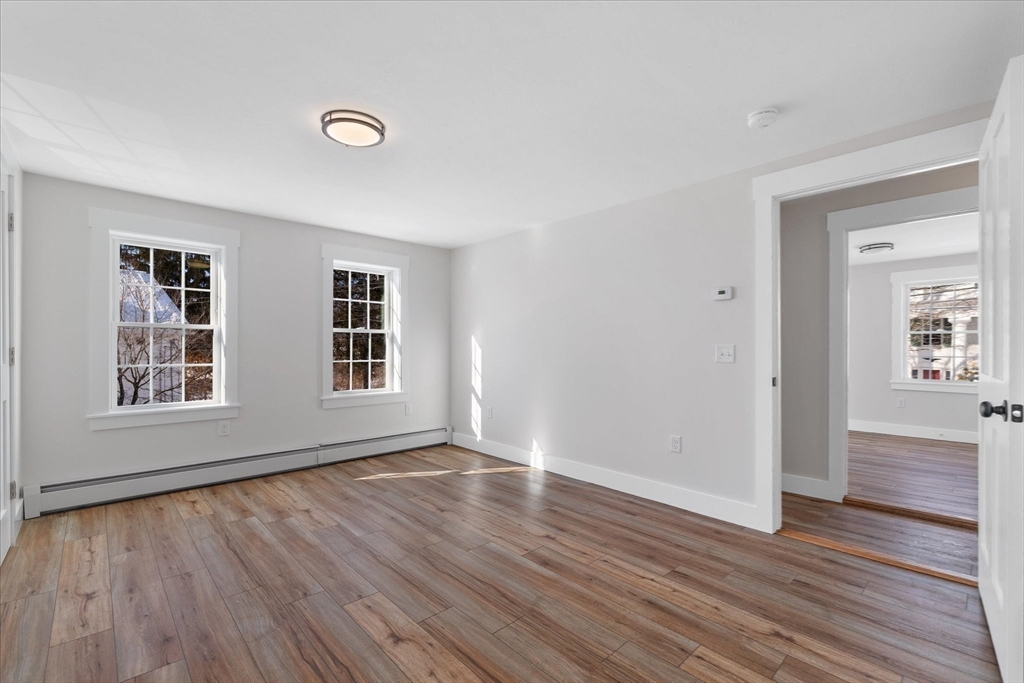 67 Maple Street Oakham, MA 01068 - Photo 35 of 41 a view of an empty room with wooden floor and a window