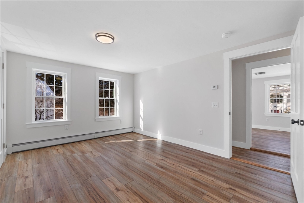 67 Maple Street Oakham, MA 01068 - Photo 36 of 42 a view of an empty room with wooden floor and a window