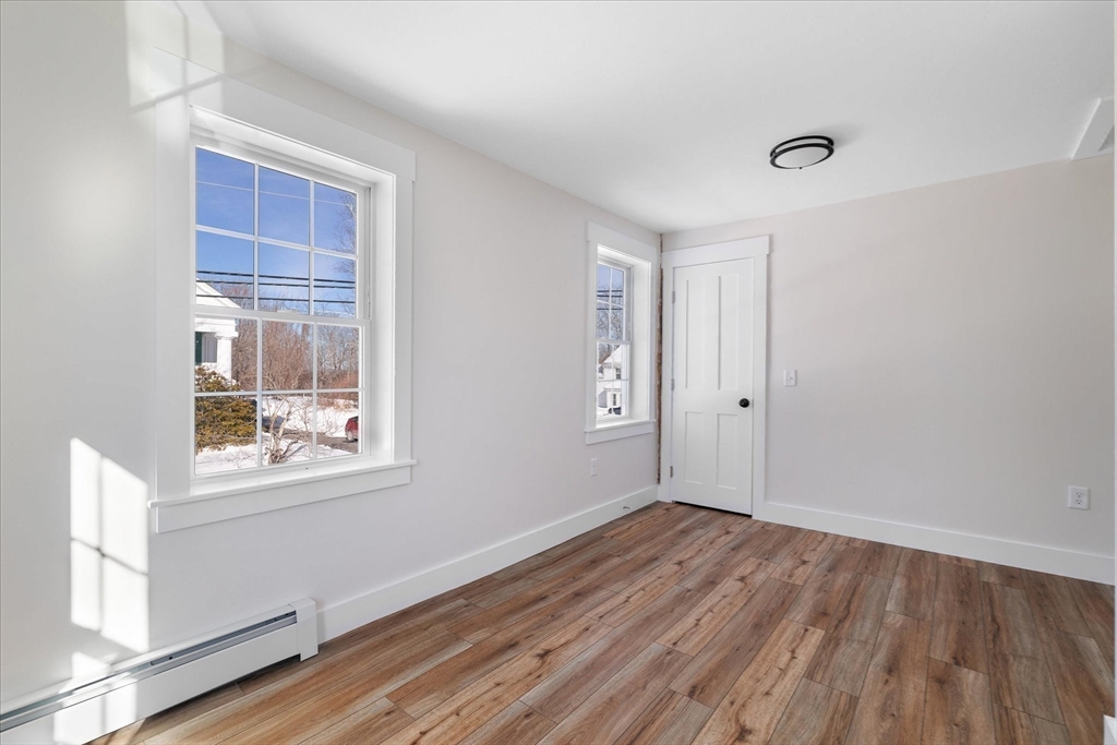 67 Maple Street Oakham, MA 01068 - Photo 36 of 41 a view of empty room with wooden floor and fan
