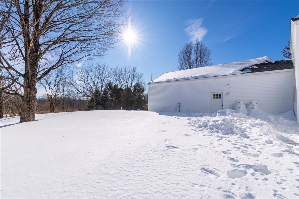 67 Maple Street Oakham, MA 01068 - Photo 42 of 42 a view of a backyard of snow