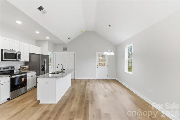 a kitchen with a sink a window and stainless steel appliances