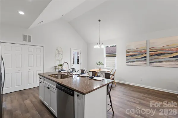 a kitchen with a sink cabinets and wooden floor