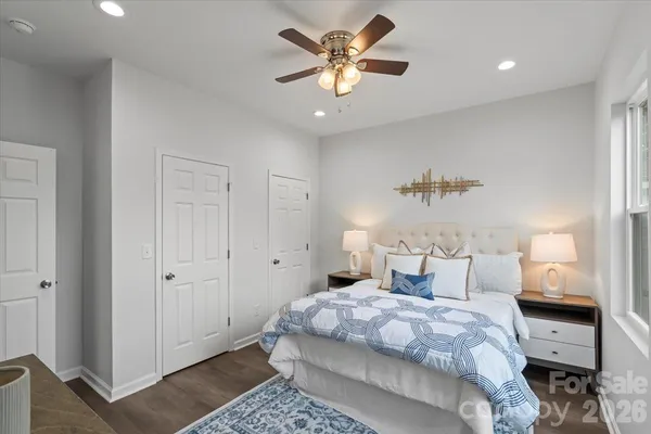 a bedroom with bed and a chandelier