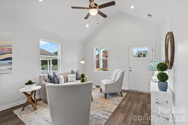a living room with furniture and a potted plant