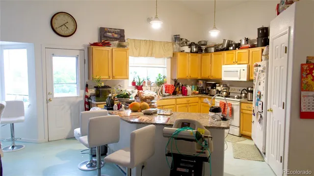 a very nice looking dining room with a large window and chairs
