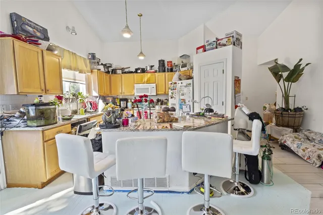 a kitchen filled with a white stove top oven sink and cabinets