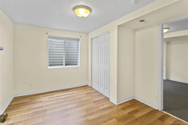 an empty room with window and entrance