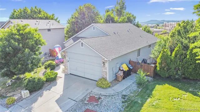 a aerial view of a house with table and chairs potted plants