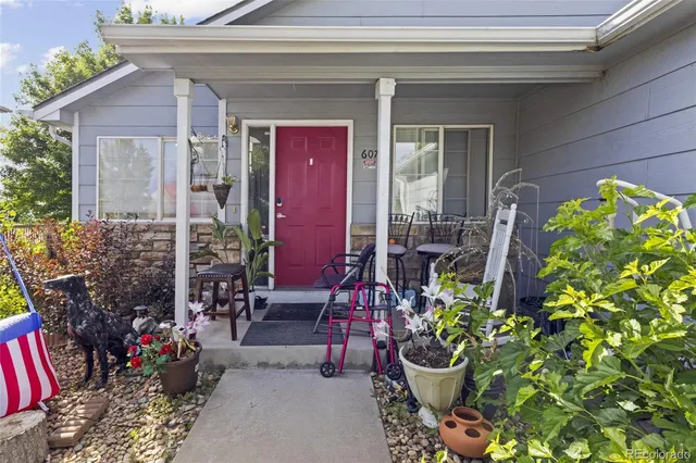 a view of a chair and table in a backyard