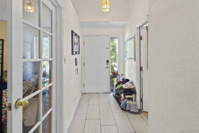 a view of a hallway with wooden floor and closet