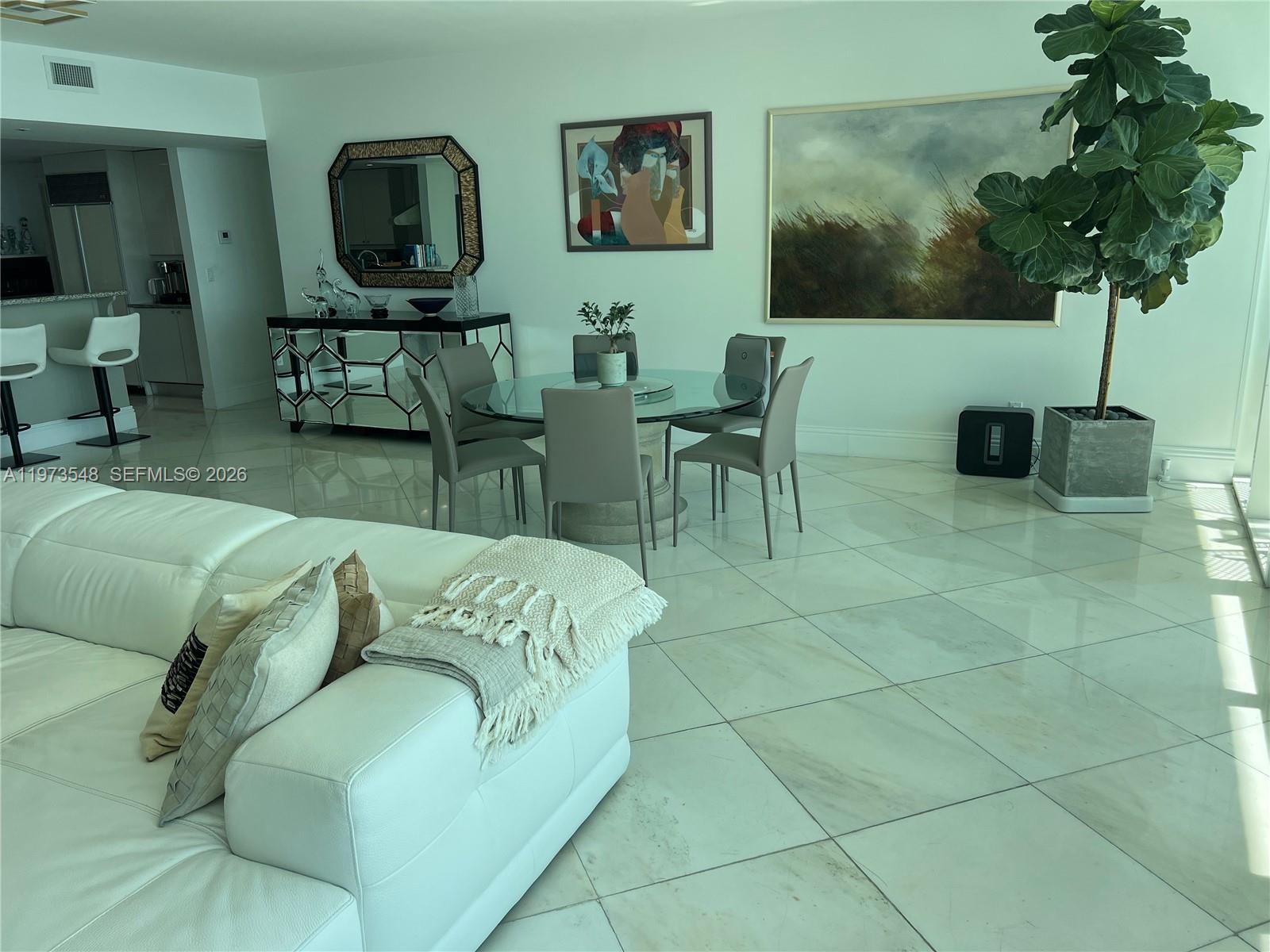 1643 Brickell Avenue, Unit 903 Miami, FL 33129 - Photo 11 of 18 a living room with furniture a potted plant and a table