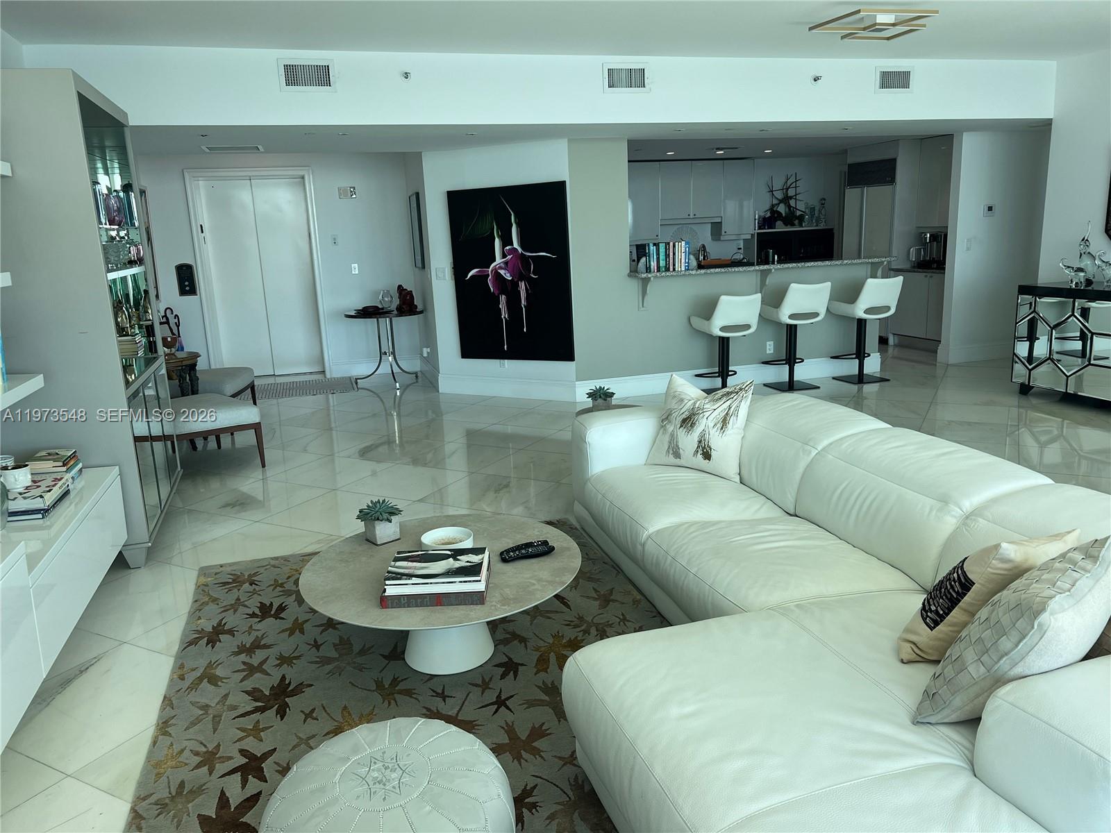 1643 Brickell Avenue, Unit 903 Miami, FL 33129 - Photo 12 of 18 a living room with furniture and wooden floor