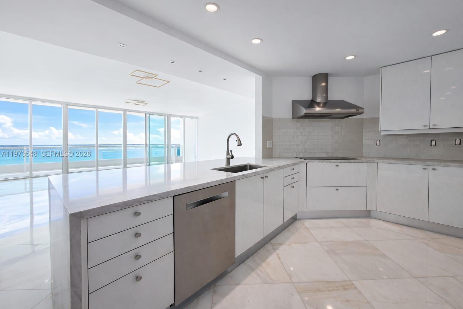 1643 Brickell Avenue, Unit 903 Miami, FL 33129 - Photo 13 of 18 a kitchen with a sink stove and cabinets