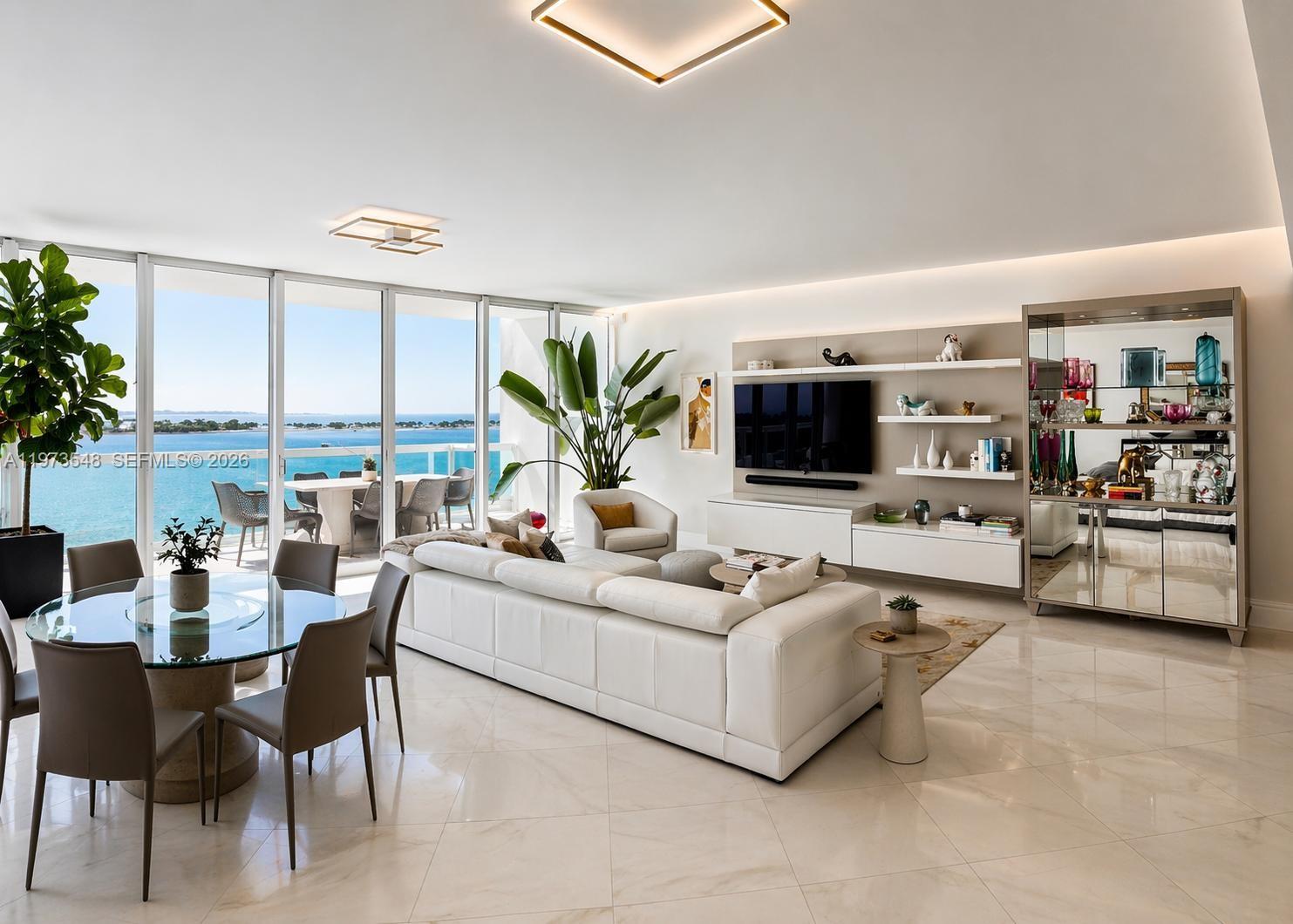 1643 Brickell Avenue, Unit 903 Miami, FL 33129 - Photo 6 of 18 a living room with furniture and a flat screen tv