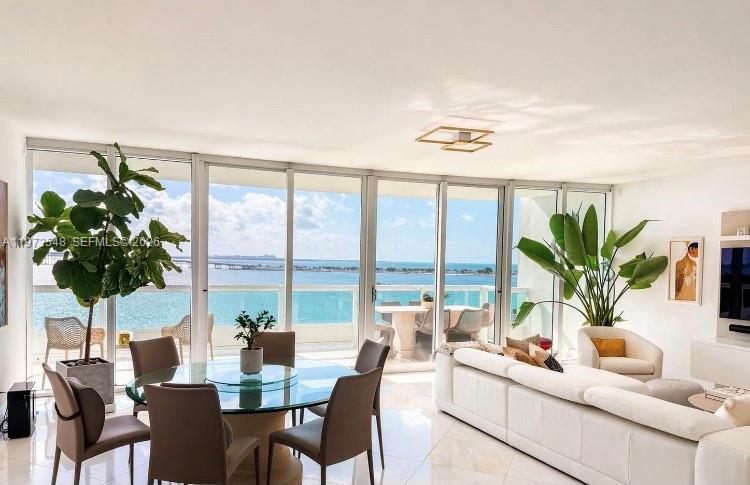 1643 Brickell Avenue, Unit 903 Miami, FL 33129 - Photo 7 of 18 a living room with furniture potted plant and a large window