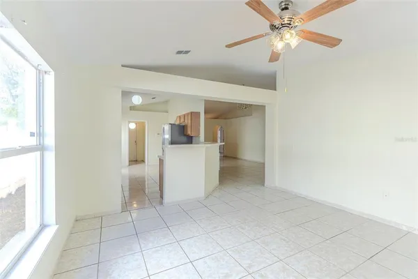 a view of a kitchen with a sink and a refrigerator